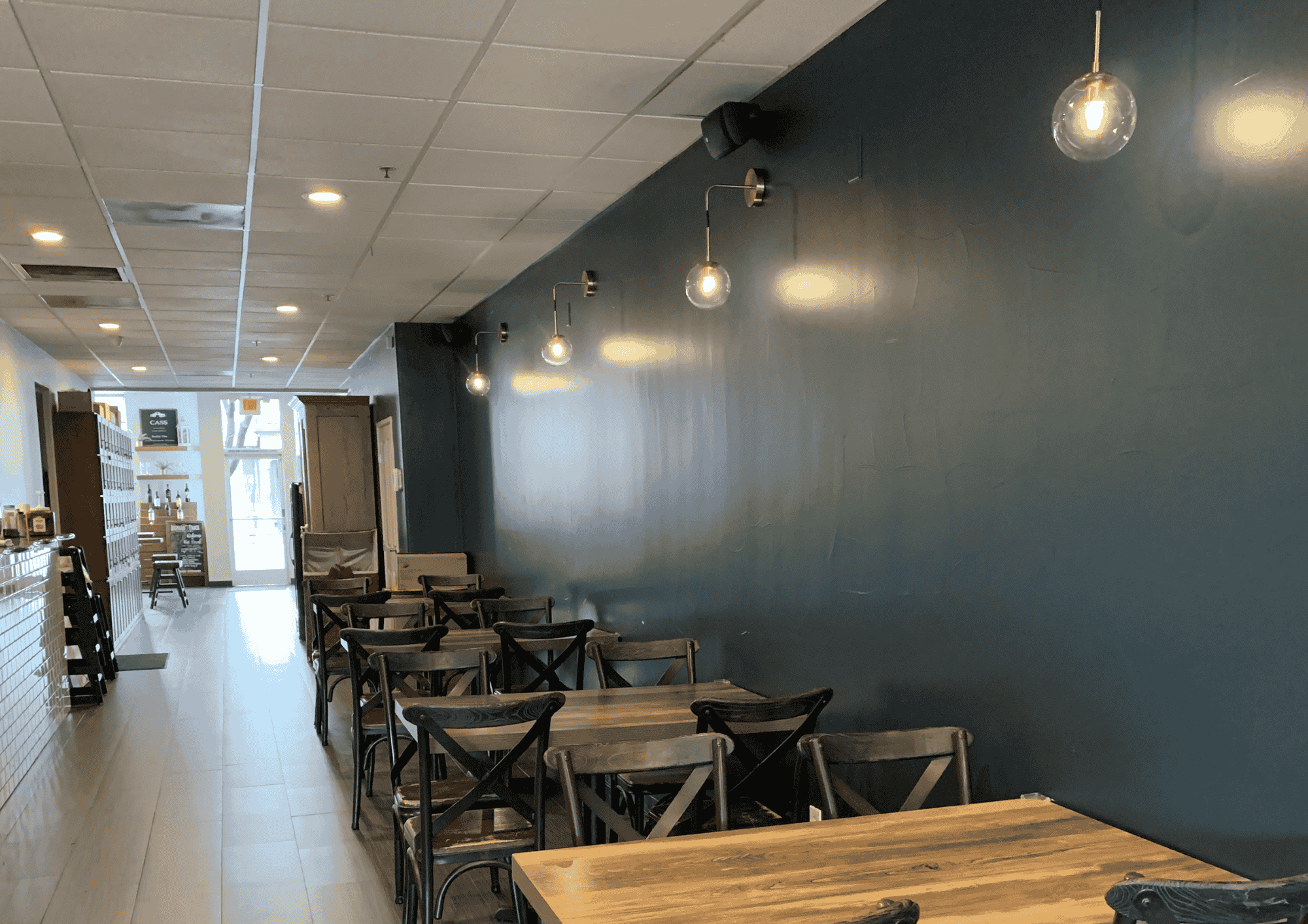 Pendant and wall-sconce lighting installed by Advanced Electric Services in a commercial dining space.